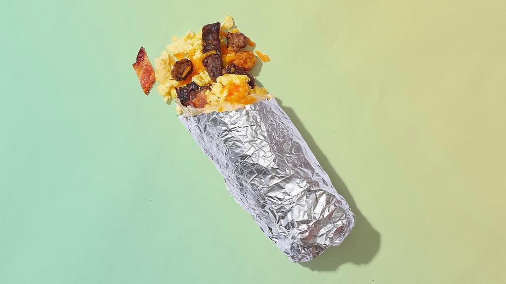 Wealthy Af · Crisp bacon, succulent sausage, tender carne asada, scrambled eggs, melted cheese, crispy tater tots, wrapped in a flour tortilla.
