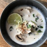 Tom Kha Soup · Spice level 1. Coconut soup with lemongrass, galangal, lime leaves, and white mushroom garni...