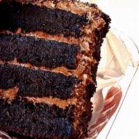 Nana's Fudgey Cake · Four fudgy layers of chocolate cake, filled with chocolate fudge frosting and chocolate gana...