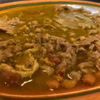 Carne en su Jugo · Beef simmered in a tomatillo sauce with bacon bits, whole beans, and veggies on the side.
Se...