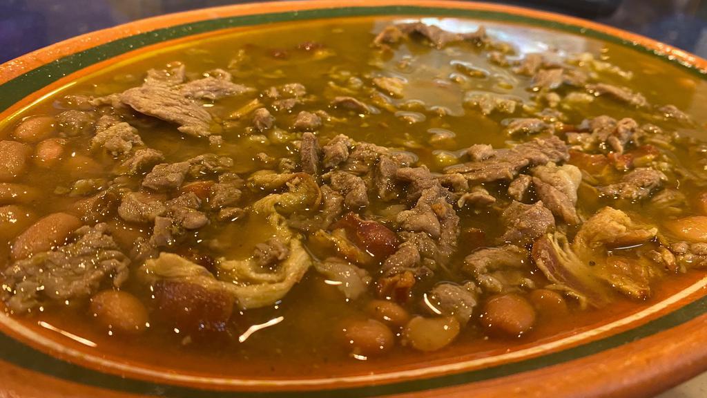 Carne en su Jugo · Beef simmered in a tomatillo sauce with bacon bits, whole beans, and veggies on the side.
Served with your choice of Tortillas.