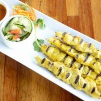 Organic Chicken Satay · Skewered char-broiled curry marinated chicken strips served with Thai peanut sauce and cucum...