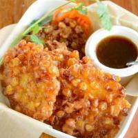 Corn Fritters · Vegan. Pan-fried sweet corn with tempura flour served with sweet and sour sauce.