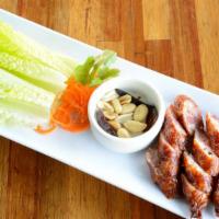 Issan Sausage · Northeastern‎ style pork and rice sausage served with peanut, lettuce and dried chili.