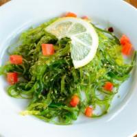 Seaweed Salad · Vegan. Garnished with sesame seeds and bell pepper.