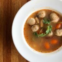 Tom Yum · Spicy and sour soup with organic chicken, mushroom, lemongrass, and kaffir lime leaves.