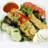 Chicken Satay Salad · Strips of chicken satay over a bed of spring mix, hard-boiled egg, tomatoes, cucumber, and b...