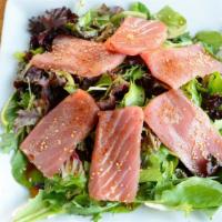 Tuna Sesame Salad · Big-eye sashimi tuna, sliced on a bed of spring mix and sesame seeds with a splash of ponzu ...