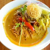 Kao Soi (Dinner) · Northern‎ Thai yellow curry over egg noodles, chicken, chopped shallot, chopped pickled must...