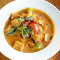 Tofu in Red Curry / Kang Daeng Tofu · Fried tofu, basil leaves, bell peppers, and bamboo shoot in red curry. Mild spicy.
