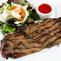 Grilled Marinated Pork · (Moo yang) grilled pork shoulder marinated with Thai herbs, and spices. Served with spring m...