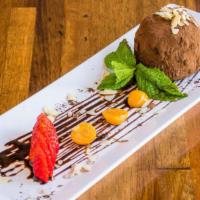Chocolate Gelato Truffle · Zabaione cream center, surrounded by chocolate gelato, and caramelized hazelnuts, topped wit...