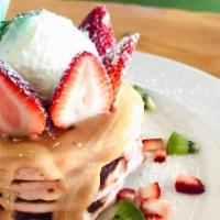 Pink Guava Pancakes · guava chiffon pancakes, tropical pink guava sauce, our whipped cream and fresh strawberries