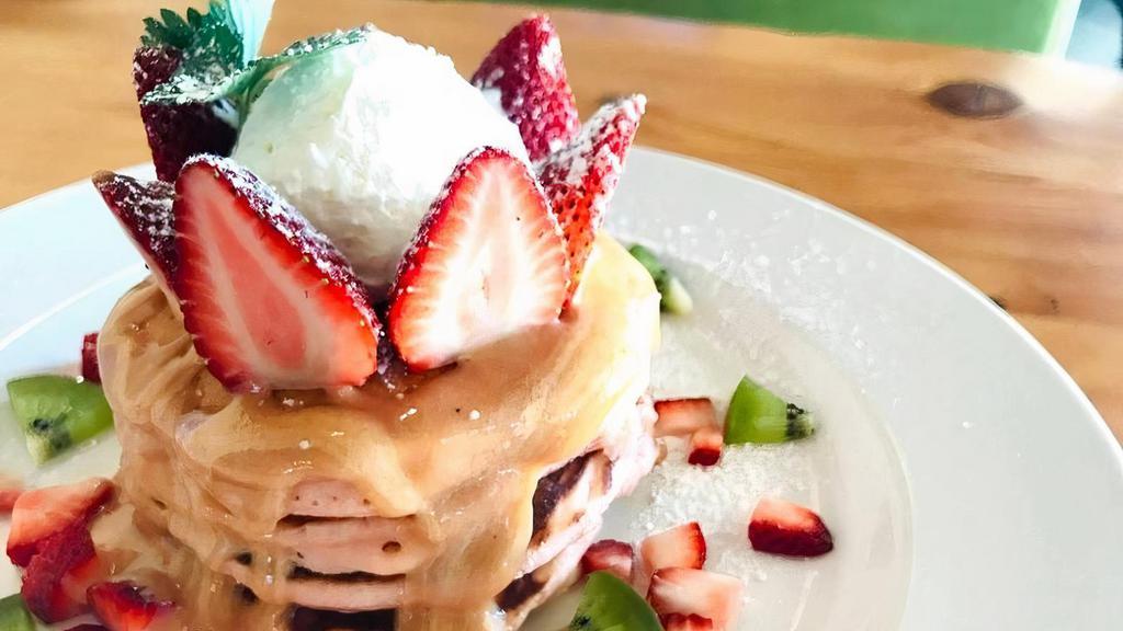 Pink Guava Pancakes · guava chiffon pancakes, tropical pink guava sauce, our whipped cream and fresh strawberries
