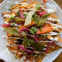 Loaded Nachos · Housemade Cheese Sauce, Pickled Jalapenos, Green Onions, Roasted Salsa, Pico de Gallo & Crem...