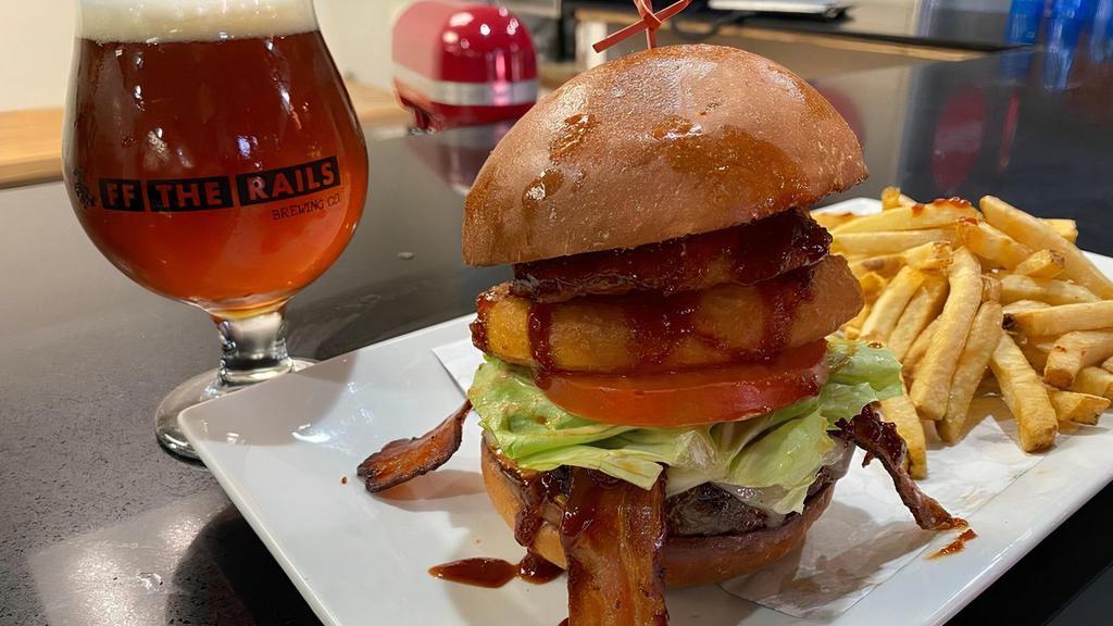 The Western Burger · White cheddar, bacon, pickles, lettuce, tomato, house made onion rings, topped with house bourbon BBQ sauce and Chris's secret sauce on signature blend patty and house made brioche bun. Served with choice of French fries or salad.
