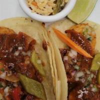 Grilled Prawn Tacos · Guajillo Chili, grilled Prawn, Fresh White Corn Tortillas, grilled Onions & peppers, Roasted...