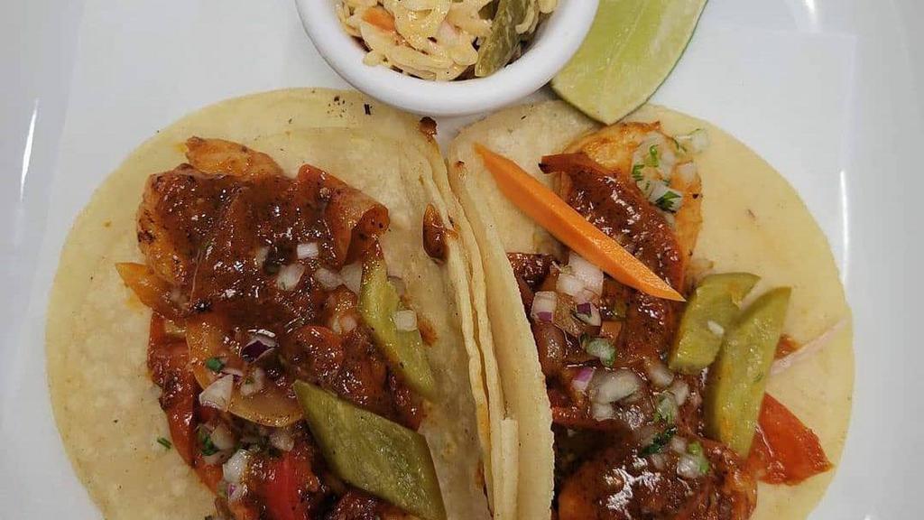 Grilled Prawn Tacos · Guajillo Chili, grilled Prawn, Fresh White Corn Tortillas, grilled Onions & peppers, Roasted Tomatillo Salsa