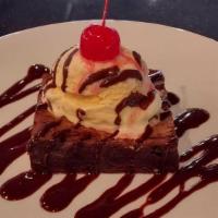 CHOCOLATE CHIP BROOKIE · Part brownie part chocolate chip cookie, served with vanilla ice cream topped with chocolate...
