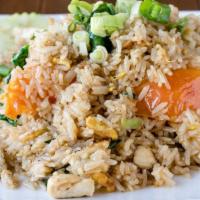 Pineapple Fried Rice · Fried rice with egg, chicken, shrimp, pineapple, raisin, cashew nut, tomatoes, garlic, and o...