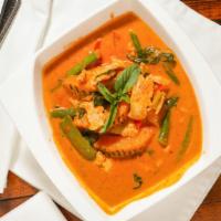 Pumpkin Red Curry · Kabocha squash, green bean, bell pepper, and Thai basil leaves in a red curry.