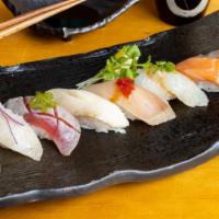 Omakase Nigiri · Nine pc chef's choice of premium nigiri plate served with soup and seaweed salad.