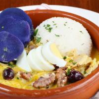 Aji de Gallina (Chicken Stew) · Pulled chicken stew, aji amarillo cream sauce, hard-boiled egg, potato, olives, walnuts, and...