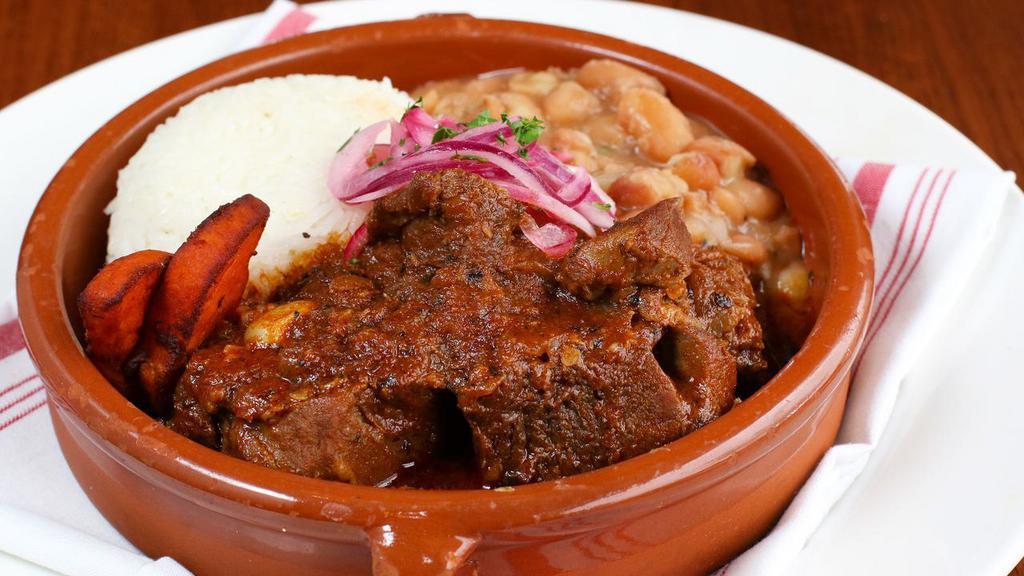 Pork Adobo · Slow braised pork shoulder, aji panca sofrito, roasted yam, canario beans, jasmine rice, and salsa criolla.