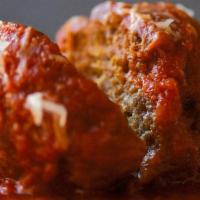 Meatball In Sauce · Meatballs served in pasta sauce garnished with finely chopped parsley.
