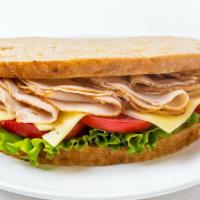 Turkey Breast Sandwich · Fresh slices of turkey breast with mayonnaise, mustard, cheese, onions, lettuce and tomatoes...