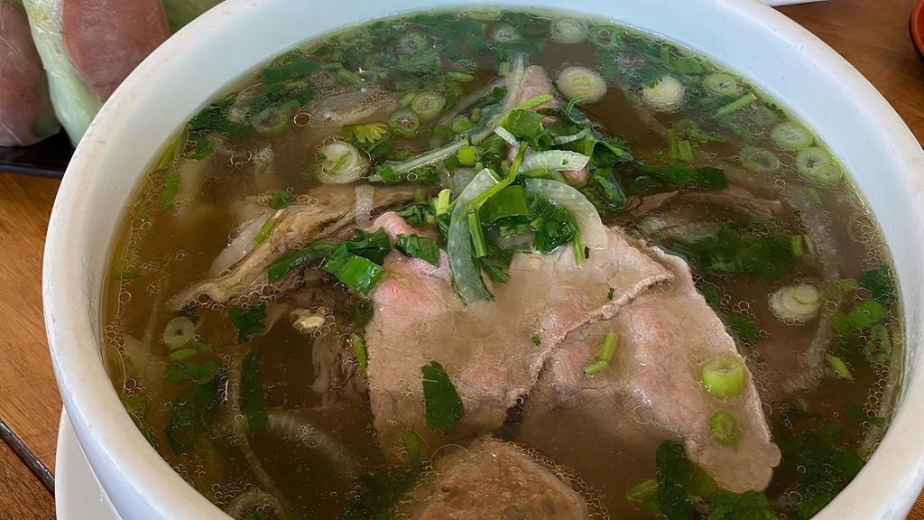 20. Phở đặc Biệt · Pho combination with rare steak, brisket and flank, tendon, tripe and meat ball.