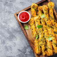 Pesto Twists · Fresh baked bread topped with garlic and pesto sauce.