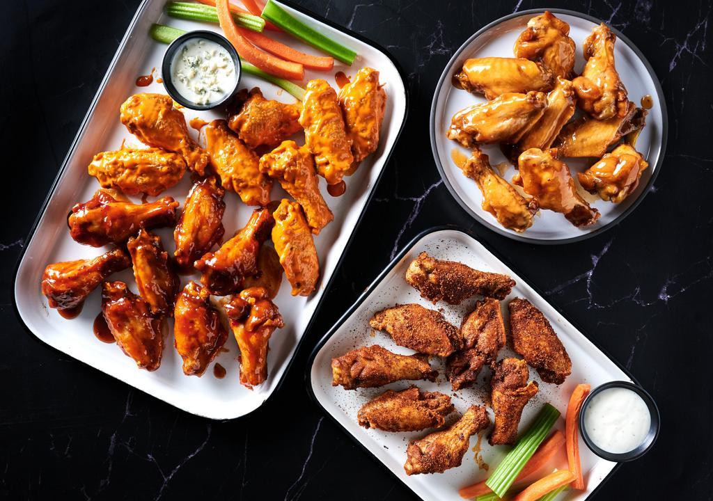 The Bracket Buster · A 32 count order of wings in two different flavors, with 4 Fries and 4 Drinks. Comes with Ranch or Blue Cheese Dipping sauces, celery and carrots