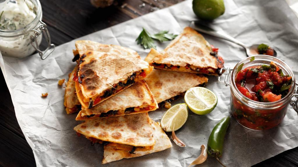 The Spicy Veggie Quesadilla · Spicy! Thinly sliced, fresh, seasonal vegetables (including tomatoes, mushrooms, onions and peppers), and loads of our melty cheese blend, folded in a large, soft flour tortilla and grilled until brown and crispy.
