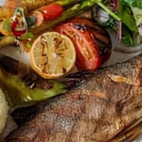 Grilled Whole Branzino · Grilled Mediterranean Seabass, grilled, and sautéed seasonal vegetables, rice pilaf