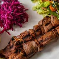 Kuzu Shish Kebab · 48 hours marinated grilled lamb skewers and vegetable pilaf. Served with rice pilate and sal...