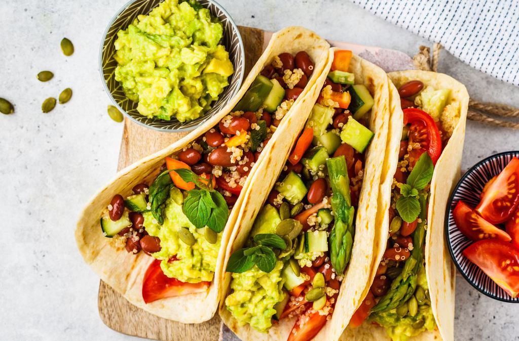 The Veggie Taco Game · Rice, beans, onions, cilantro, hot salsa, cheese, sour cream, avocado, lettuce. Served with chips & salsa.