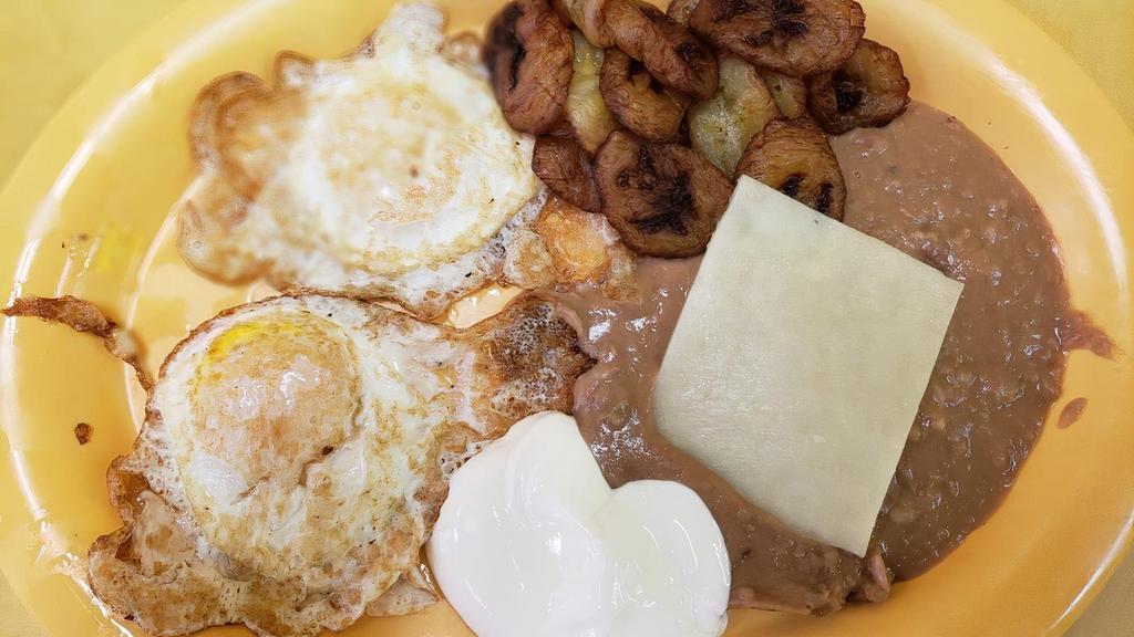 47. Desayuno Hondureño · Two over easy eggs, tajadas, refried beans, cheese, & sour cream.