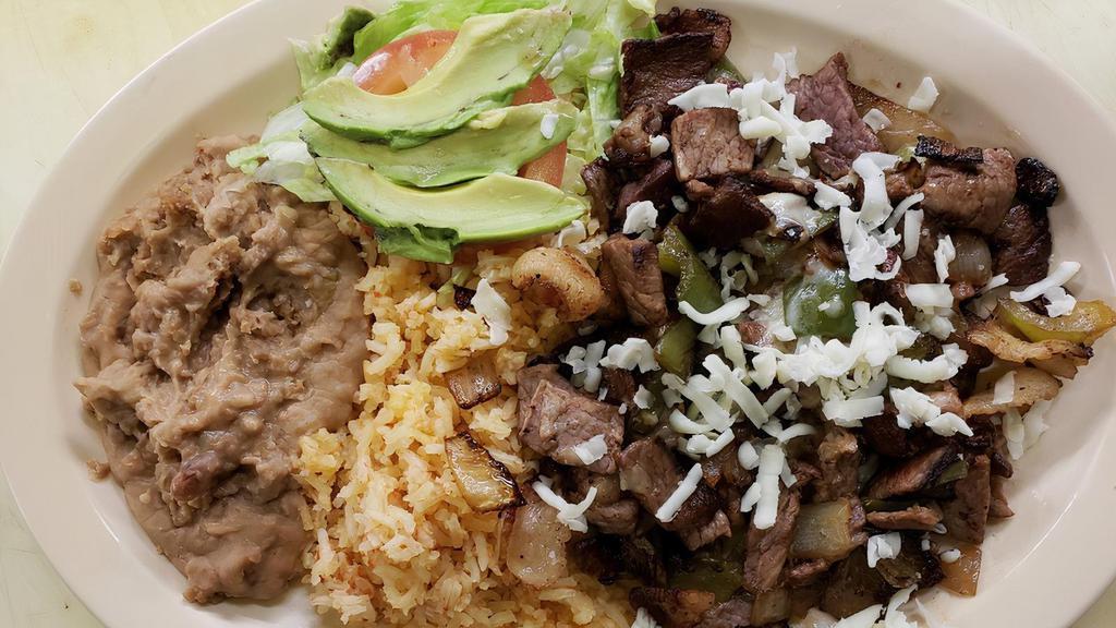 57. Alambre · Chunks of grilled steak, bacon, onion and bell pepper served with rice, beans, salad, and tortillas.