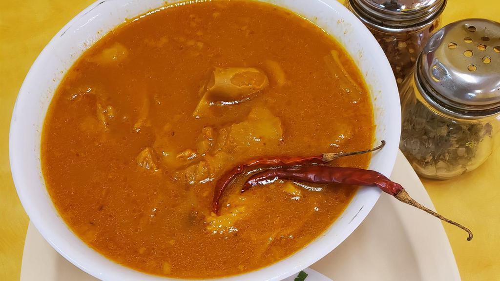 Menudo · Traditional Mexican soup, made with cow's stomach (tripe) in broth with a red chili pepper base.