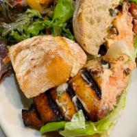 Salmon Sandwich · Grilled Salmon filet, tomato and butter lettuce with house tartar sauce on a toasted rustic ...