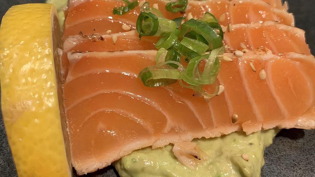 Guaca Sake · Pan-seared Norwegian salmon with garlic and pepper, served on a bed of garlic guacamole, citrus soy vinaigrette.  (3.5oz) (Popular)