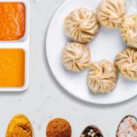 Juicy Chicken Momos · Steamed juicy chicken Nepali dumplings served with traditional dipping sauce. 8 Pieces.