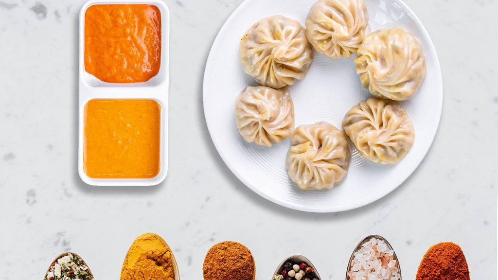Juicy Chicken Momos · Steamed juicy chicken Nepali dumplings served with traditional dipping sauce. 8 Pieces.