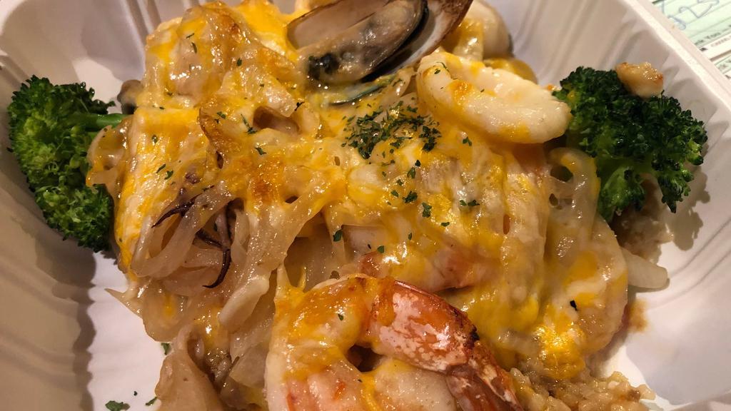 Seafood Rice Gratin · Shrimp, scallop, calamari, green mussel, onions, and tomatoes.