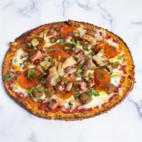 Meat Your Heart Out · Homemade cauliflower based pizza crust topped with red sauce, pepperoni, sausage, chicken, h...