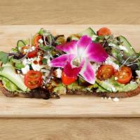 Veggie Toasty · Classic avocado toast on artisan sourdough bread with topped with cucumbers, cherry tomatoes...