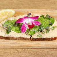 Hummus Toasty · Artisan sourdough bread with our classic hummus, topped with sliced avocado, micro greens, o...