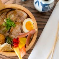 Chashu Don · Japanese rice bowl topped with seared pork belly, with sides of soft boiled egg, gyoza, tako...