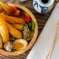 Shrimp Tempura Don · Japanese rice bowl topped with shrimp tempura with sides of a soft boiled egg, gyoza, takoya...